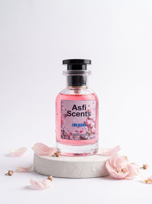 Blush by Asfi Scents on a stone pedestal with flowers