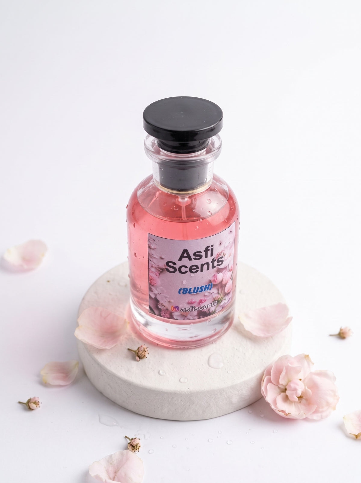 Blush perfume on a stone with petals